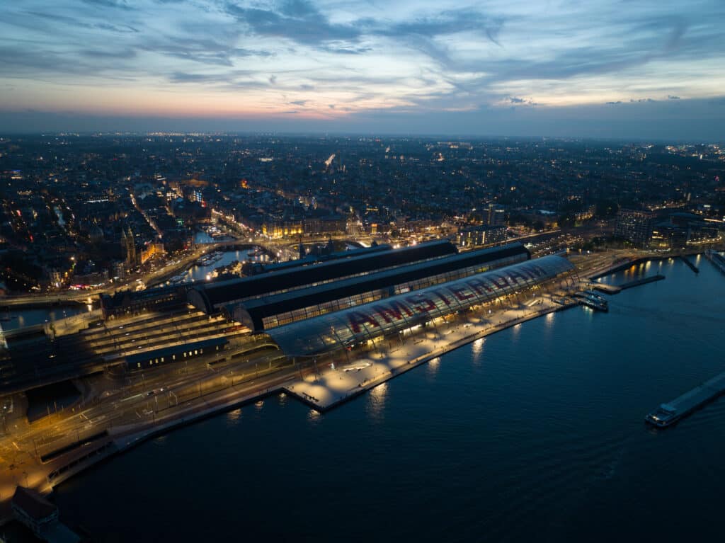Aerial drone view of the skyline of Amsterdam, central station train station and city center, The Netehrlands.