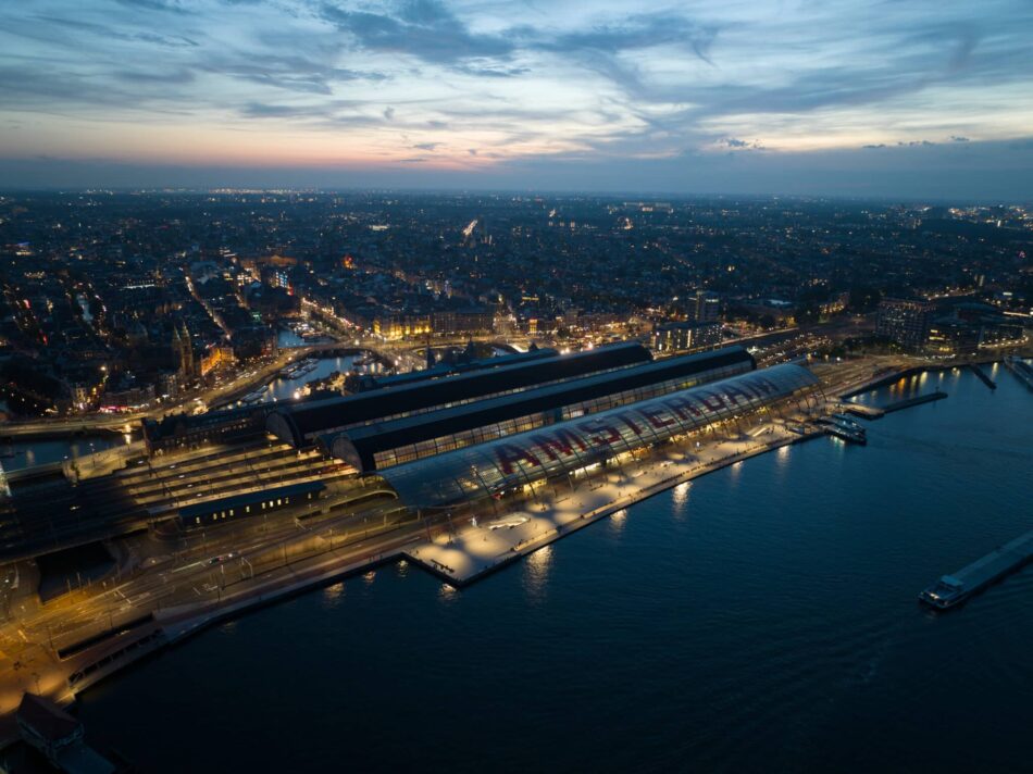 Aerial drone view of the skyline of Amsterdam, central station train station and city center, The Netehrlands.