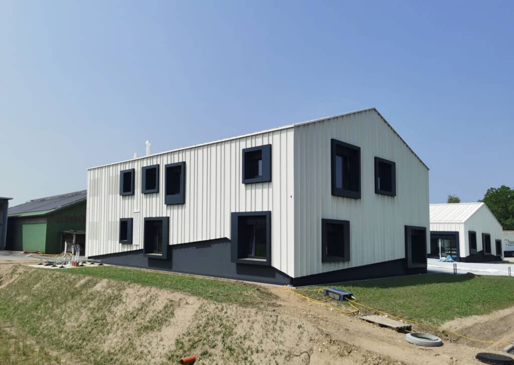 Rückseite des Bürogebäudes mit strukturierter Fassadenverkleidung und dunklen Fensterumrahmungen