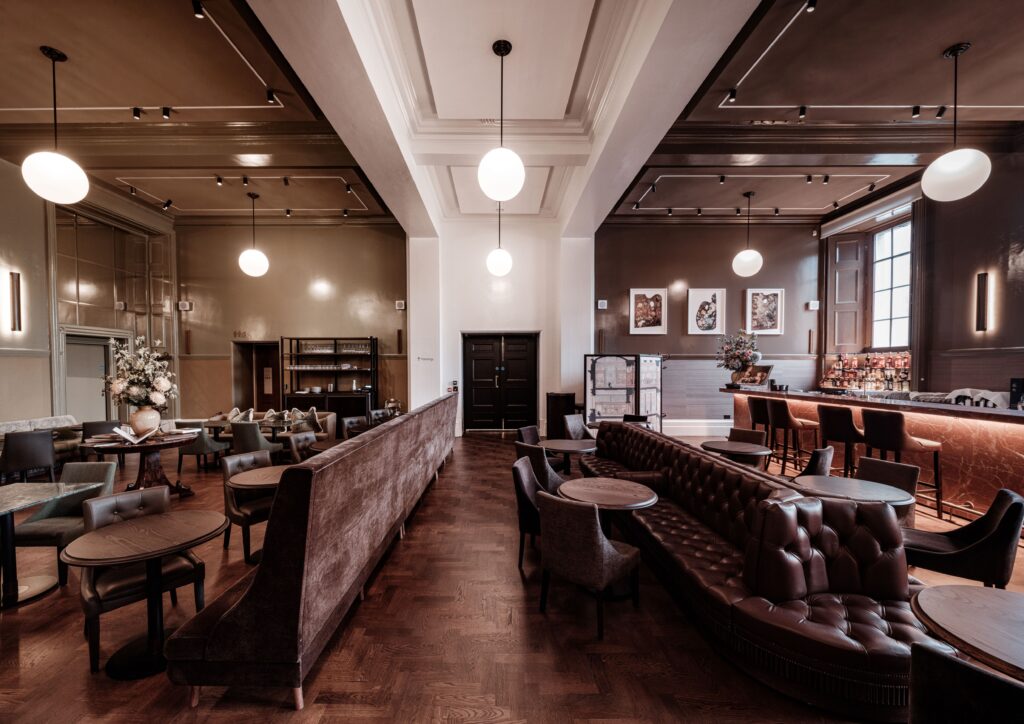 Großzügiger Gastraum mit Lounge- und Barbereich, kombiniert aus klassischen und modernen Elementen.