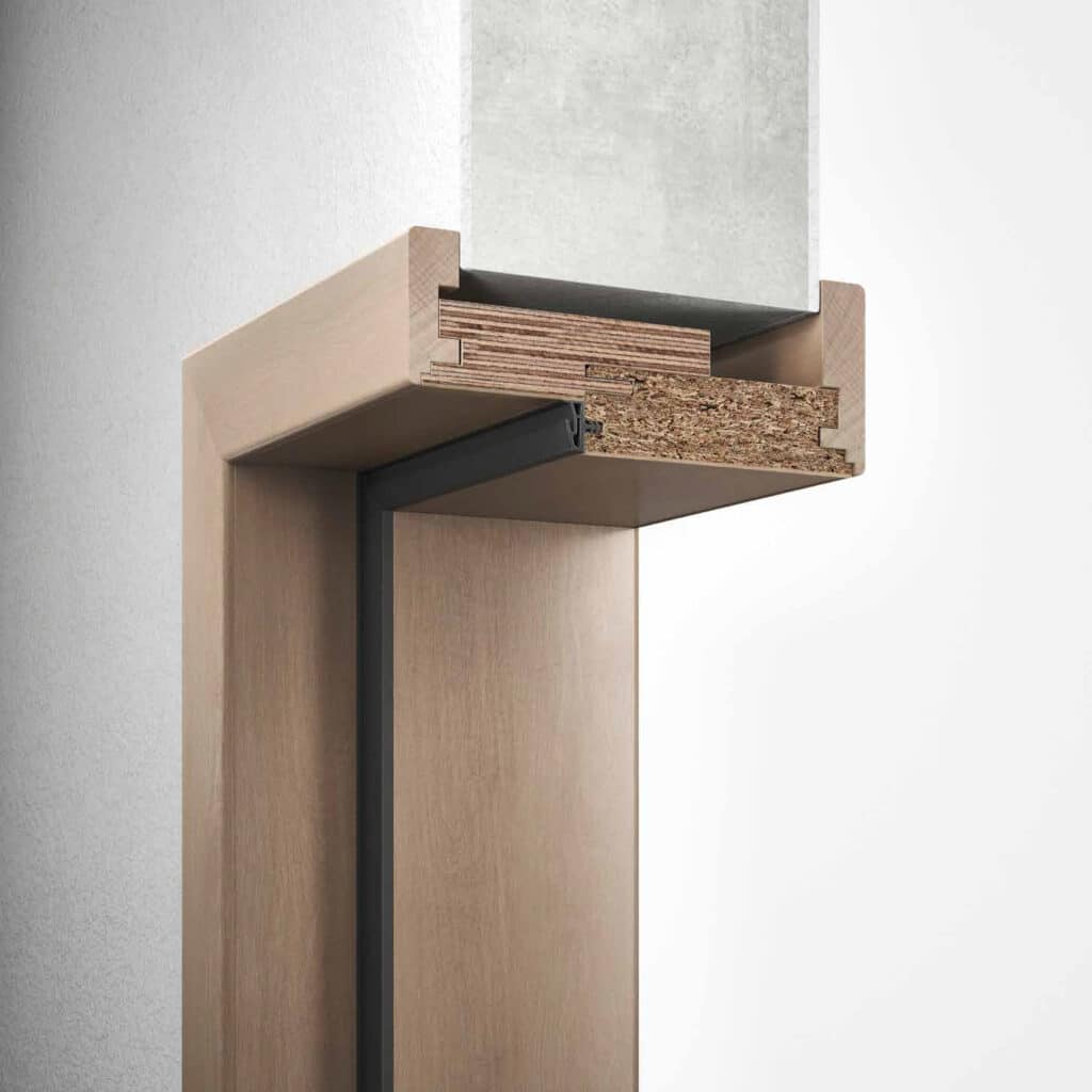 Querschnitt einer Holz-Umfassungszarge mit Türdichtung und Einbau im Mauerwerk