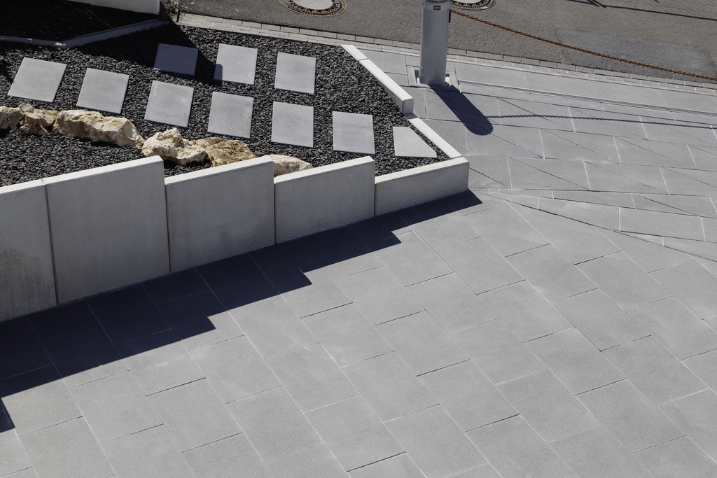 Außenanlage mit Betonstützwinkeln zur Abfangung von Höhenunterschieden und Treppenanlage