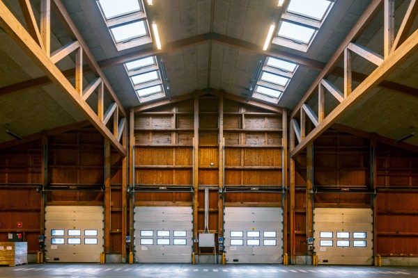 Helle Industriehalle aus Holz im LKR Innovation House Bestand 1 mit Sektionaltoren und Dachfenstern.