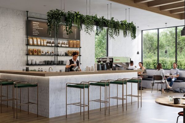 Barista im modernen Café vor dem fugenlosen Wandsystem Altro Tegulis in heller Marmoroptik an der Theke.