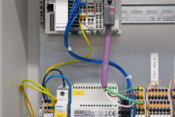 myGEZE Control Hardware für Gebäudeautomation in Hutschaltermontage im Schaltschrank mit Netzteil und Verkabelung.