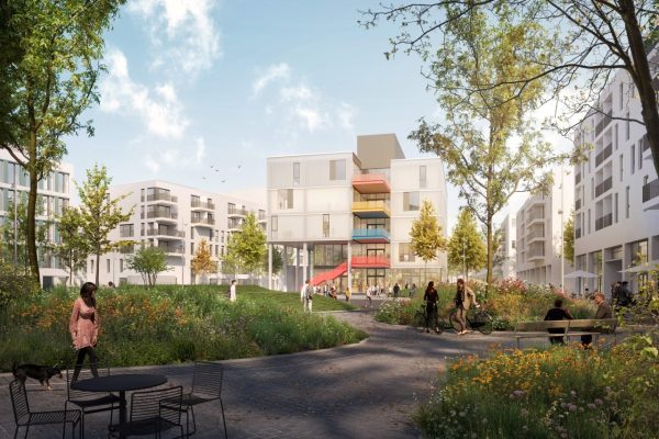Modernes GOLDBECK Marienhöfe Quartiersgebäude mit bunten Balkonen inmitten einer grünen Parkanlage.